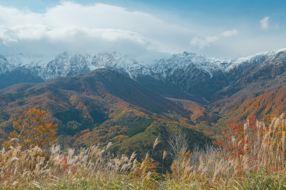Scenic mountain view with snowy peaks and autumn foliage in Japan